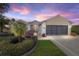 Attractive tan house with a three-car garage and landscaping at 15692 Sw 11Th Court Rd, Ocala, FL 34473