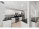 Modern kitchen with white cabinets, granite countertops, and stainless steel appliances at 15692 Sw 11Th Court Rd, Ocala, FL 34473