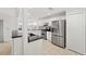 Modern kitchen with white cabinets, granite countertops, and stainless steel appliances at 15692 Sw 11Th Court Rd, Ocala, FL 34473