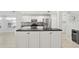 Modern kitchen with white cabinets, granite counters, and stainless steel appliances at 15692 Sw 11Th Court Rd, Ocala, FL 34473