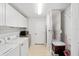 Bright laundry room with washer, dryer, and cabinets at 15692 Sw 11Th Court Rd, Ocala, FL 34473