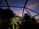 Night view from inside a screened enclosure with palm trees at 15692 Sw 11Th Court Rd, Ocala, FL 34473
