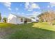 Spacious backyard with grassy lawn and a screened-in patio at 1616 San Diego St, The Villages, FL 32159