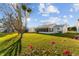 Back of house with screened porch and large lawn at 1616 San Diego St, The Villages, FL 32159