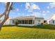 Spacious backyard with a screened patio and lush grass at 1616 San Diego St, The Villages, FL 32159