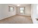 Bright bedroom with neutral carpeting and two windows at 1616 San Diego St, The Villages, FL 32159
