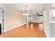 Bright dining room with hardwood floors and kitchen access at 1616 San Diego St, The Villages, FL 32159