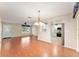 Open dining room with hardwood floors and kitchen view at 1616 San Diego St, The Villages, FL 32159