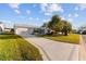 Front view of a single-story house with a driveway and landscaping at 1616 San Diego St, The Villages, FL 32159