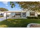 House exterior with a spacious lawn and driveway at 1616 San Diego St, The Villages, FL 32159