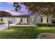 House exterior at dusk with well-maintained lawn at 1616 San Diego St, The Villages, FL 32159