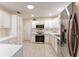 Modern kitchen featuring stainless steel appliances and white cabinets at 1616 San Diego St, The Villages, FL 32159