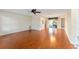 Bright living room featuring hardwood floors and a ceiling fan at 1616 San Diego St, The Villages, FL 32159