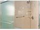 Walk-in shower with glass enclosure and built-in shelving at 1616 San Diego St, The Villages, FL 32159