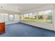 Bright sunroom featuring a ceiling fan and view of the backyard at 1616 San Diego St, The Villages, FL 32159