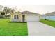 Charming single-story home with well-manicured lawn, stone accents, and an attached two-car garage at 16434 Se 81St Ter, Summerfield, FL 34491