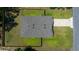 An aerial view of a home featuring a fenced yard, driveway, and well-maintained roof with vents at 1664 Sw 167Th St, Ocala, FL 34473
