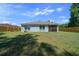 View of the backyard featuring a lawn, wood fence, windows, and a screened in porch at 1664 Sw 167Th St, Ocala, FL 34473