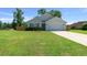 Charming single-story house with a long driveway, healthy green lawn, and attached two-car garage at 1664 Sw 167Th St, Ocala, FL 34473