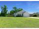 Beautiful one-story house with expansive green lawn, long driveway, and attached two-car garage at 1664 Sw 167Th St, Ocala, FL 34473