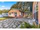 Exterior view showing the home's light peach siding and stone patio at 1670 Se 169Th Terrace Rd, Silver Springs, FL 34488