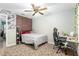 Bedroom with brick accent wall and a workspace at 20 Cherry Ln, Ocala, FL 34472