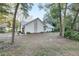 House's side view, showcasing stone accents and a carport at 20 Cherry Ln, Ocala, FL 34472