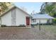 Front view of a charming house with red door and stone accents at 20 Cherry Ln, Ocala, FL 34472