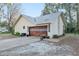 House exterior featuring an attached garage with a wood-like door at 20 Cherry Ln, Ocala, FL 34472