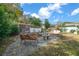 Relaxing backyard with fire pit, seating area, and mature trees at 2004 Ne 52Nd St, Ocala, FL 34479