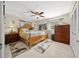 Spacious bedroom with a king-size bed, dresser, and ceiling fan at 2004 Ne 52Nd St, Ocala, FL 34479