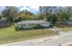 Light green ranch style home with attached garage and mature landscaping at 2004 Ne 52Nd St, Ocala, FL 34479