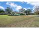 Light green house with a spacious lawn and mature trees at 2004 Ne 52Nd St, Ocala, FL 34479
