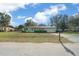 Ranch home with a spacious lawn and a detached garage at 2004 Ne 52Nd St, Ocala, FL 34479