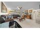 Spacious living room with tile floors, a sectional sofa, and a ceiling fan at 2004 Ne 52Nd St, Ocala, FL 34479