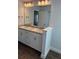 Bathroom featuring double vanity with granite countertop and a large mirror at 2142 Nw 23Rd Loop, Ocala, FL 34475