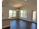 Dining area with hardwood floors and a stylish chandelier adjacent to the kitchen at 2142 Nw 23Rd Loop, Ocala, FL 34475