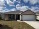Charming one-story home featuring a two-car garage and well-maintained lawn at 2142 Nw 23Rd Loop, Ocala, FL 34475