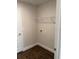 Compact laundry area with tiled flooring and a convenient wire shelf at 2142 Nw 23Rd Loop, Ocala, FL 34475
