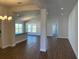 Open concept living and dining area with wood floors and a view of the kitchen at 2142 Nw 23Rd Loop, Ocala, FL 34475