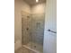 Modern bathroom featuring a walk-in shower with stylish tile and glass door, complemented by sleek fixtures at 2146 Nw 23Rd Loop, Ocala, FL 34475