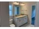Bathroom with double sink vanity, granite countertop, and large mirror at 2146 Nw 23Rd Loop, Ocala, FL 34475