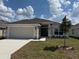 Charming single-story home with a well-manicured lawn and attached two-car garage at 2146 Nw 23Rd Loop, Ocala, FL 34475