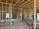 Unfinished interior showcasing framing work, concrete floors, and natural light at 2146 Nw 23Rd Loop, Ocala, FL 34475