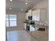 Bright kitchen with stainless steel appliances, granite countertops, and white cabinets at 2146 Nw 23Rd Loop, Ocala, FL 34475