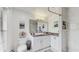 Modern bathroom with white cabinets, marble floors, and walk-in shower at 21668 Sw Peach Blossom St, Dunnellon, FL 34431