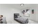 Bedroom with black leather bed, marble floors, and window at 21668 Sw Peach Blossom St, Dunnellon, FL 34431