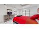 Comfortable bedroom with a red bedspread and access to a private patio at 21668 Sw Peach Blossom St, Dunnellon, FL 34431