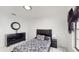 Bedroom with black leather bed, marble floors, and window at 21668 Sw Peach Blossom St, Dunnellon, FL 34431