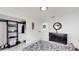Bedroom with black dresser, closet, and patterned bedding at 21668 Sw Peach Blossom St, Dunnellon, FL 34431
